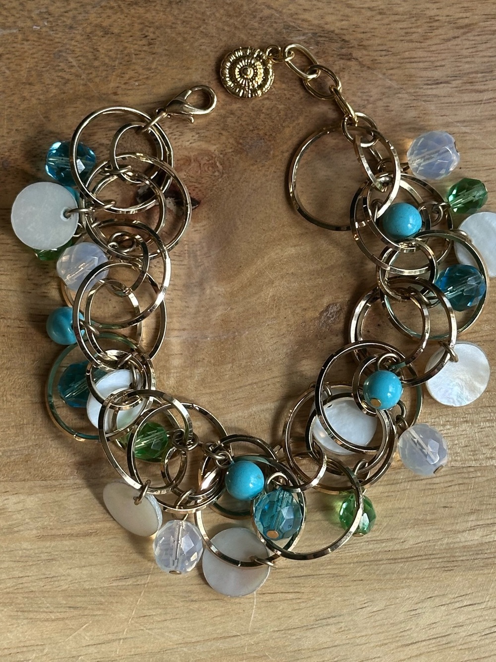 New, never worn Graziano Gold Tone Turquoise Mother of Pearl Charm Bracelet